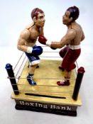 A cast iron novelty boxing money bank