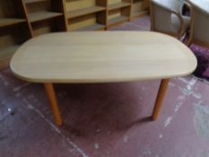 A Danish oval coffee table in a pine finish
