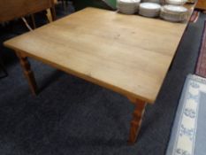 A blonde oak square coffee table