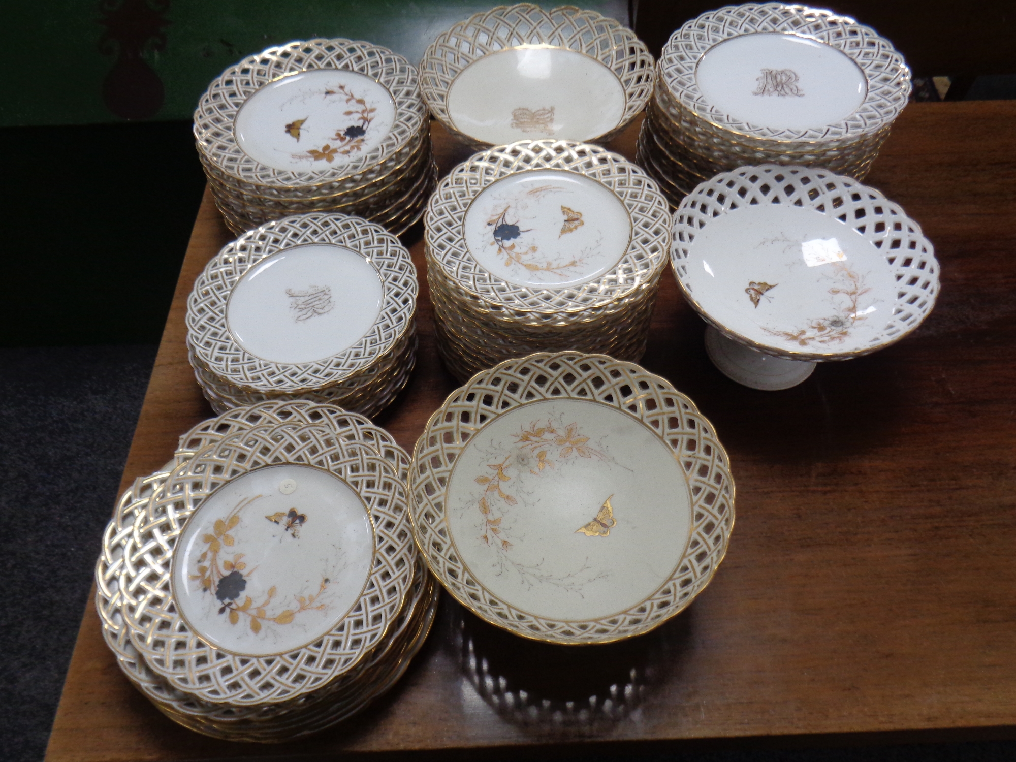 A quantity of 19th century white and gilt lattice comports and plates