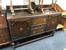 An Edwardian oak double door sideboard fitted two central drawers