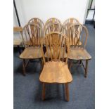 Seven oak wheel back dining chairs