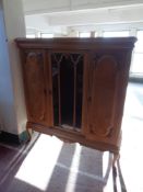 A 20th century continental oak triple door sideboard on raised cabriole legs