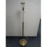 A 20th century heavy brass rise and fall standard lamp on circular base