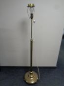 A 20th century heavy brass rise and fall standard lamp on circular base