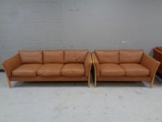 A 20th century Scandinavian wood framed three seater settee and two seater settee upholstered in