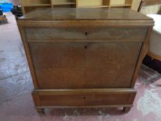 A 20th century continental oak serving cabinet fitted two drawers