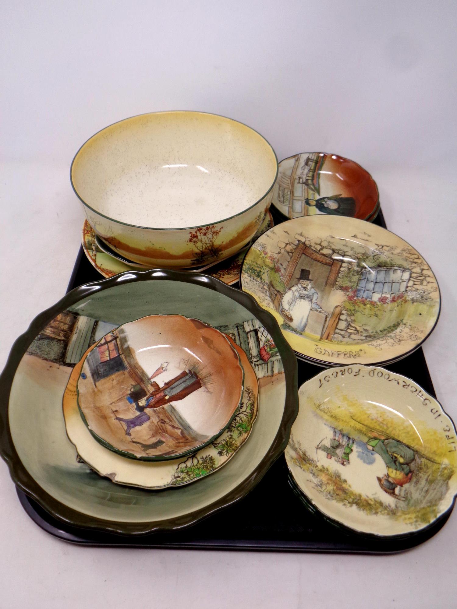 A tray containing fourteen pieces of Royal Doulton china to include Dickens ware and Robin Hood