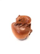 A Japanese carved fruitwood netsuke - Rat on a pumpkin.