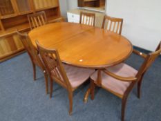 A mid 20th century oval teak extending dining table,