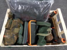 A crate containing assorted fishing equipment to include rod stands, Fox camo bag, wallets,