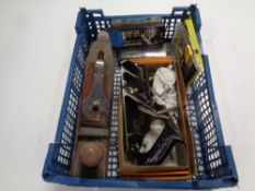 A crate containing a small quantity of tools to include Record woodworking plane, drill bits,