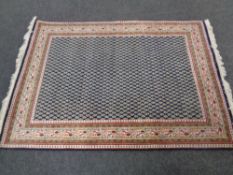 A Persian design rug on blue ground,
