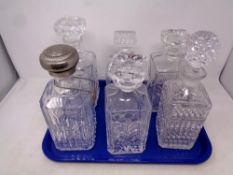 A tray containing six assorted cut glass and lead crystal decanters