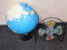 A globe on stand together with a battery operated clock in the form of a vintage fan