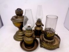 Four antique brass oil lamps with shades