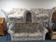 A three piece lounge suite upholstered in a floral fabric