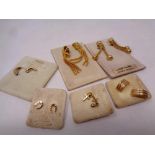 Six pairs of gold plated earrings