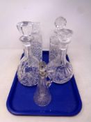 A tray containing four assorted lead crystal and cut glass decanters together with a cut glass