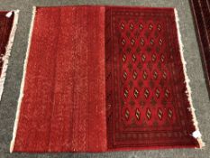 An eastern fringed cushion cover on red ground,