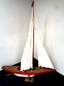 A large wooden model of a pond yacht on stand,