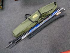 A Zebco fishing rod bag containing carp poles by Shimano,