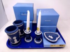 A tray containing five pieces of Wedgwood Jasperware to include candlesticks,