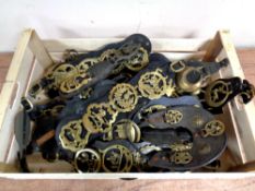 A box containing a large quantity of horse brasses on leather straps