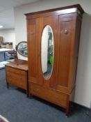 An Edwardian mahogany three piece bedroom suite comprising of mirrored door wardrobe fitted drawer