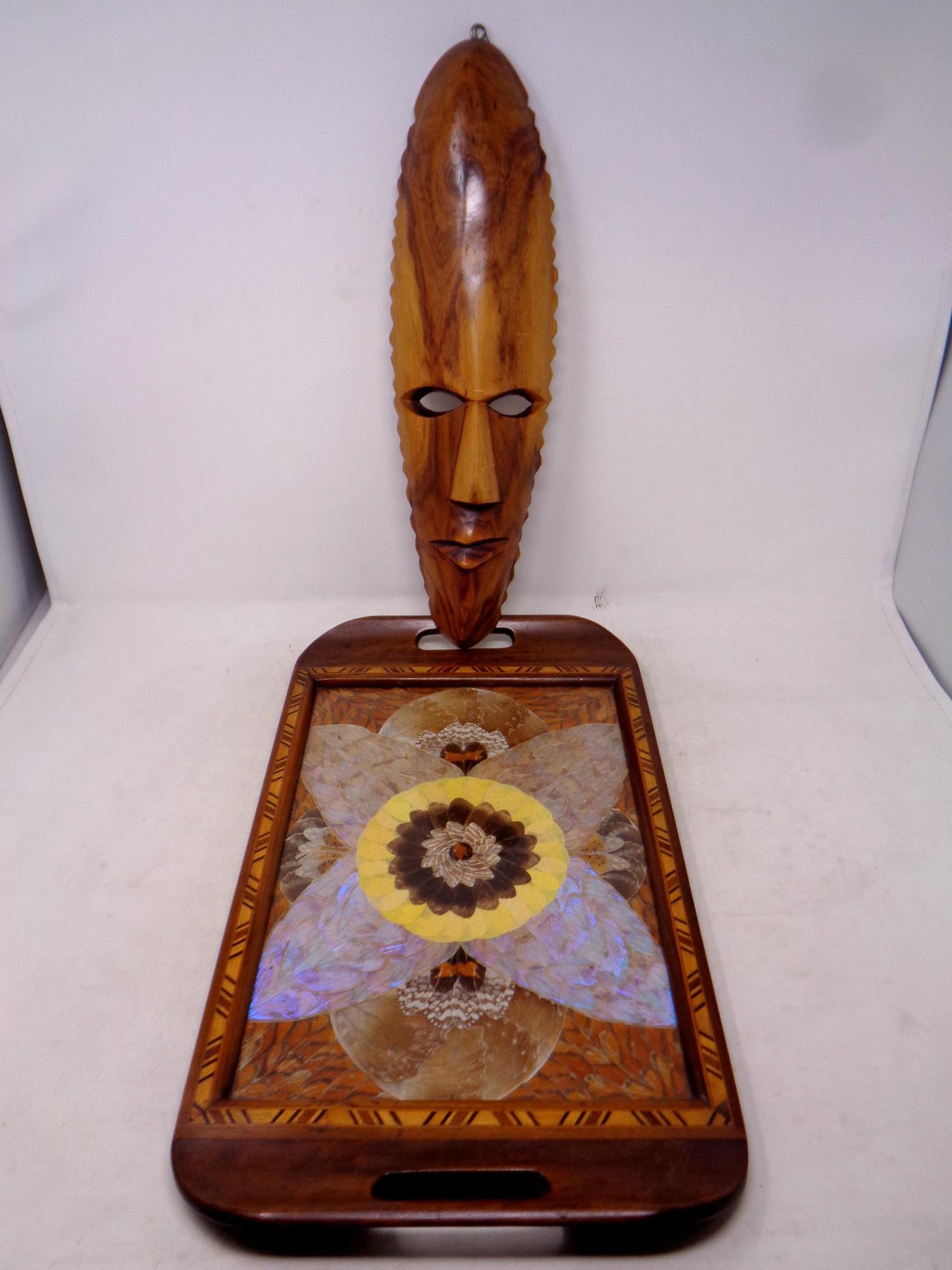 A 20th century tourist butterfly tray together with a carved wall mask