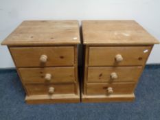 A pair of pine three drawer bedside chests