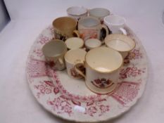 A 19th century meat plate containing assorted mugs, teacups and egg cups, Queen Victoria onwards,