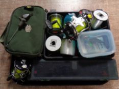 A tray containing assorted fishing equipment to include two Abu Garcia reels, fishing line,