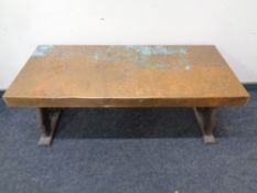 An antique hammered copper topped refectory coffee table,