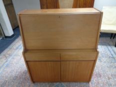 A mid 20th century teak Remploy writing bureau fitted double door cupboard and two drawers beneath,