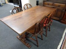 An oak refectory dining table together with two pairs of Windsor dining chairs