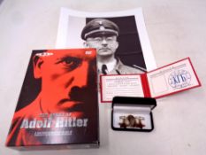 A monochrome picture of Heinrich Himmler together with an Adolf Hitler DVD box set,
