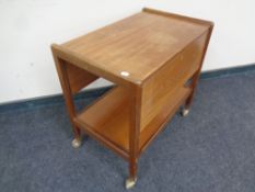 A mid 20th century teak flap sided serving trolley