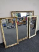 A gilt framed bevel edged overmantel mirror together with two further framed hall mirrors