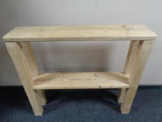 A narrow rustic pine two tier table