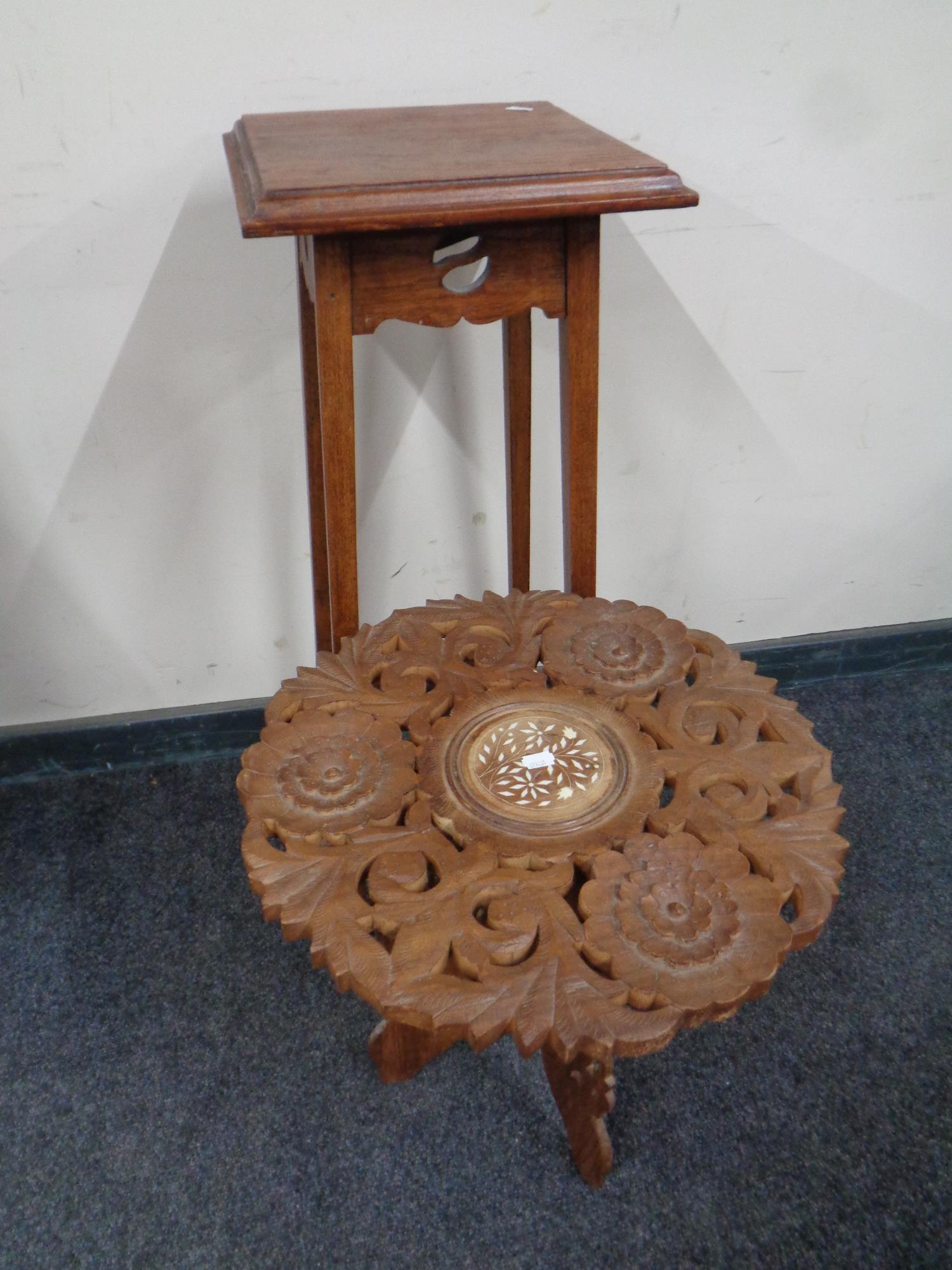 An Edwardian oak Arts and Crafts plant stand together with a carved eastern wine table