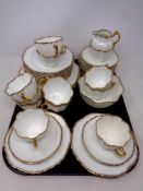 A tray containing 40 pieces of 19th century white and gilt tea china