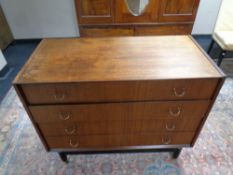 A mid 20th century teak G Plan E Gomme four drawer chest on raised legs,