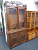 A 19th century carved mahogany double door glazed bookcase fitted cupboards and drawers beneath