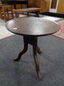 A 19th century mahogany wine table on three way pedestal