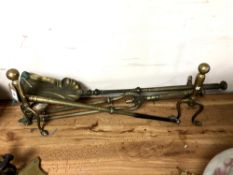 A set of antique brass fire dogs with irons