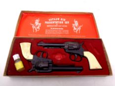An Outlaw Kid presentation set of repeating cap guns in original box