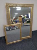 A contemporary gilt framed bevel edged overmantel mirror together with a further gilt framed mirror