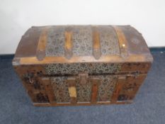 A late 19th century wooden bound tooled leather dome topped shipping trunk