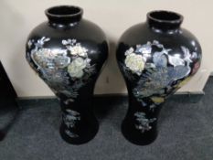 A pair of Japanese black lacquered vases with mother of pearl decoration, height 64.